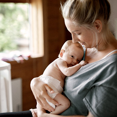 Mother holding her baby (photo)