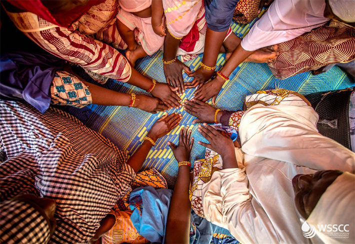 Women displaying MHM bracelets at their wrists (photo)