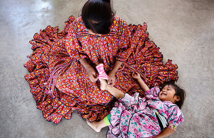 Girl puts socks on a baby (photo)