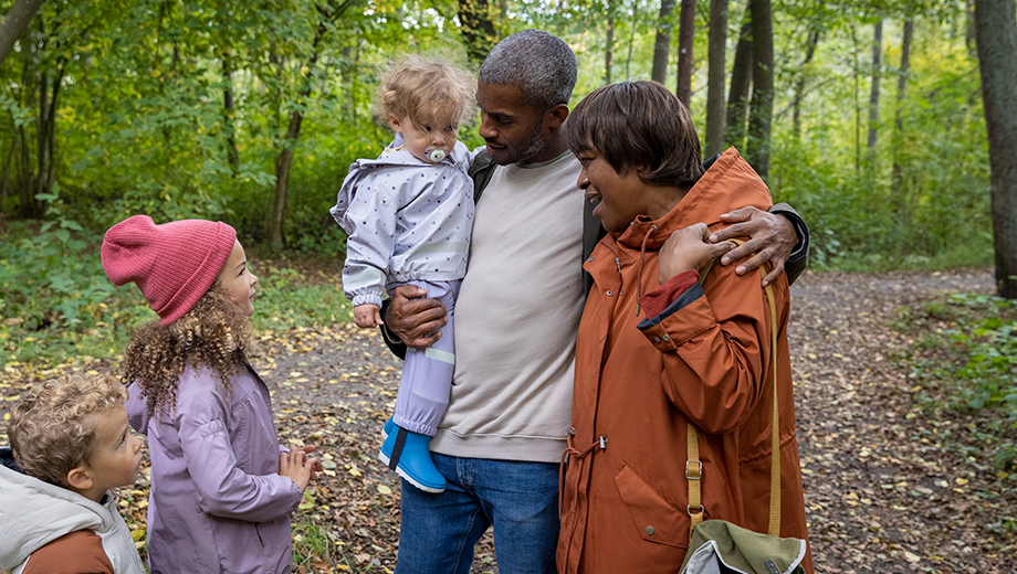 Man with a woman and kids in the woods